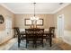Bright dining room with a decorative chandelier, crown molding, neutral walls, and stylish furnishings at 8368 Rambling River Dr, Sanford, FL 32771