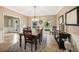 Formal dining room featuring a decorative chandelier, neutral walls, and travertine flooring at 8368 Rambling River Dr, Sanford, FL 32771