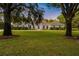 Well-maintained single-story home features a lush green lawn framed by mature shade trees at 8368 Rambling River Dr, Sanford, FL 32771