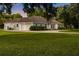 Spacious single-story home featuring a detached garage, circular driveway, and mature landscaping at 8368 Rambling River Dr, Sanford, FL 32771