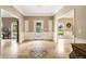 Elegant foyer with marble floors, mosaic inlay, decorative moulding, and classic front door with sidelights at 8368 Rambling River Dr, Sanford, FL 32771