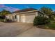 Detached garage with white door, side entry, well-maintained landscaping, and concrete driveway at 8368 Rambling River Dr, Sanford, FL 32771