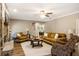 Spacious living room with a fireplace, ceiling fan, hardwood floors, and a neutral color palette at 8368 Rambling River Dr, Sanford, FL 32771