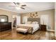 Spacious main bedroom featuring a ceiling fan, wood floors, large window and walk in closet at 8368 Rambling River Dr, Sanford, FL 32771