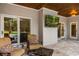 Inviting covered patio with comfortable seating, outdoor TV, and sliding glass doors to bring the outdoors in at 8368 Rambling River Dr, Sanford, FL 32771