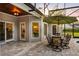 Relaxing outdoor dining area with a beautiful wood ceiling and an umbrella at 8368 Rambling River Dr, Sanford, FL 32771