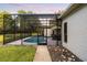 A lovely screened-in pool offers a refreshing escape, complimented by an outdoor dining area for poolside enjoyment at 8368 Rambling River Dr, Sanford, FL 32771