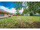 Lush backyard view, complete with green grass, a storage shed, and fencing at 855 Third St, Orange City, FL 32763
