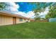 Backyard showcasing a well-manicured lawn, shed and the home's exterior at 855 Third St, Orange City, FL 32763