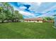 Expansive backyard showing a grassy lawn and a view of the home's exterior at 855 Third St, Orange City, FL 32763