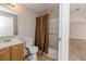Bathroom with neutral walls, tile flooring, vanity and shower with neutral curtain at 855 Third St, Orange City, FL 32763