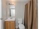 Bathroom featuring neutral walls, vanity, tile flooring and shower with neutral curtain at 855 Third St, Orange City, FL 32763