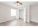 Bedroom featuring light gray walls, wood-look flooring, window, and closet with open door at 855 Third St, Orange City, FL 32763