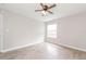 Bright bedroom featuring modern ceiling fan, light gray walls, window and light wood-look flooring at 855 Third St, Orange City, FL 32763