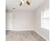 Bedroom with light gray walls, wood-look flooring and a window with neutral blinds at 855 Third St, Orange City, FL 32763