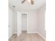 Bedroom featuring light gray walls, wood-look flooring and an open closet at 855 Third St, Orange City, FL 32763