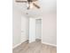 Bedroom with light gray walls, wood-look flooring and an open closet at 855 Third St, Orange City, FL 32763