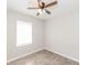 Bright bedroom featuring modern ceiling fan, light gray walls, and a window with neutral blinds at 855 Third St, Orange City, FL 32763