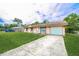 Cozy home with a large driveway and well-manicured lawn at 855 Third St, Orange City, FL 32763