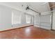Empty garage featuring a garage door and two windows with blinds at 855 Third St, Orange City, FL 32763