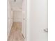 Hallway leading to a room with wood-look floors and ceiling fan at 855 Third St, Orange City, FL 32763