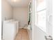 Functional laundry room with washer, dryer and door to the backyard at 855 Third St, Orange City, FL 32763