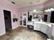 Bathroom featuring double doors, white cabinets, and tiled floors at 8935 Jonathan Manor Dr, Orlando, FL 32819