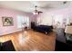 Spacious bedroom with hardwood floors, ceiling fan, and plantation shutters at 8935 Jonathan Manor Dr, Orlando, FL 32819