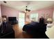 Comfortable bedroom with dark furniture, ceiling fan, and natural light at 8935 Jonathan Manor Dr, Orlando, FL 32819
