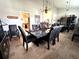 Elegant dining room featuring travertine floors, decorative chandelier, and granite table at 8935 Jonathan Manor Dr, Orlando, FL 32819