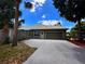 Charming one-story home with a well-maintained lawn and a spacious two-car garage at 8935 Jonathan Manor Dr, Orlando, FL 32819