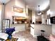 Open-concept kitchen featuring raised countertops, wooden cabinetry, stainless steel appliances, and tile flooring at 8935 Jonathan Manor Dr, Orlando, FL 32819