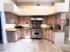 Spacious kitchen with custom cabinets, granite countertops, and stainless steel appliances, including a Viking range at 8935 Jonathan Manor Dr, Orlando, FL 32819