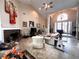 Open living room with a stone fireplace, tile flooring, and tall ceilings for great natural lighting at 8935 Jonathan Manor Dr, Orlando, FL 32819