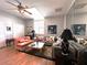 Bright living room with a vaulted ceiling, skylight and a comfortable seating arrangement including a large sectional at 8935 Jonathan Manor Dr, Orlando, FL 32819