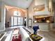 Spacious living room with high ceilings, tile flooring, and ample natural light flowing into the kitchen and front entrance at 8935 Jonathan Manor Dr, Orlando, FL 32819