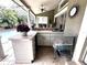 Outdoor kitchen area featuring a tiled counter, cabinets, sink and a view of the backyard pool at 8935 Jonathan Manor Dr, Orlando, FL 32819