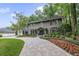 Two-story home featuring manicured flower beds, a brick driveway, and well-maintained landscaping at 981 Victoria Ter, Altamonte Springs, FL 32701