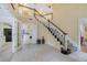 Grand foyer with staircase, tile flooring, and access to the kitchen, creating a welcoming entrance at 981 Victoria Ter, Altamonte Springs, FL 32701
