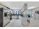 Well-lit kitchen showcasing stainless steel appliances, white cabinetry, and a view to the screened porch at 981 Victoria Ter, Altamonte Springs, FL 32701