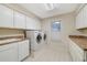 Well maintained laundry room equipped with a washer, dryer, lots of cabinetry, and a sink at 981 Victoria Ter, Altamonte Springs, FL 32701