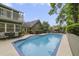 A beautiful pool with chairs, tables, and umbrellas, is set in a spacious backyard with mature trees and lush landscaping at 981 Victoria Ter, Altamonte Springs, FL 32701