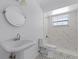 Bathroom featuring modern fixtures, including marble-look tiling at 1013 Glensprings Ave, Winter Garden, FL 34787