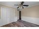This bedroom features beautiful new floors, ceiling fan and a spacious closet at 1013 Glensprings Ave, Winter Garden, FL 34787