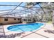 Sparkling pool with large screened-in enclosure and outdoor living area at 1013 Glensprings Ave, Winter Garden, FL 34787