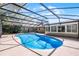 Aerial view of the sparkling pool with screened-in enclosure and backyard at 1013 Glensprings Ave, Winter Garden, FL 34787
