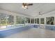 Bright sunroom with tile floor, ceiling fans, and views of the pool and backyard at 1013 Glensprings Ave, Winter Garden, FL 34787