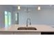 Kitchen island featuring a stainless steel sink and modern faucet at 16435 Sw 27Th Ave, Ocala, FL 34473