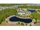 Aerial view of the community with a clubhouse, pool, playgrounds, and scenic lakes at 17313 Bracken Fern Ln, Clermont, FL 34714