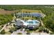 Community clubhouse featuring pools, a playground, and a beautiful lake with walking trails at 17313 Bracken Fern Ln, Clermont, FL 34714